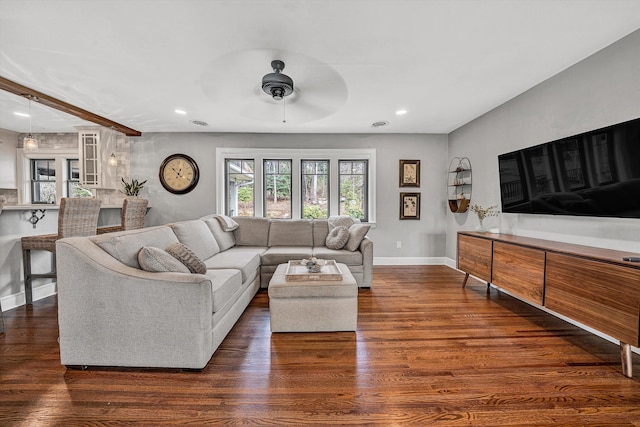 living area with plenty of natural light, wood finished floors, and baseboards