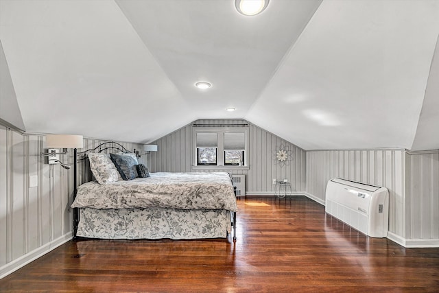 bedroom with lofted ceiling and wood finished floors