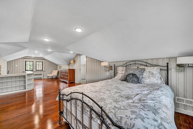 bedroom featuring visible vents, lofted ceiling, radiator, and wood finished floors