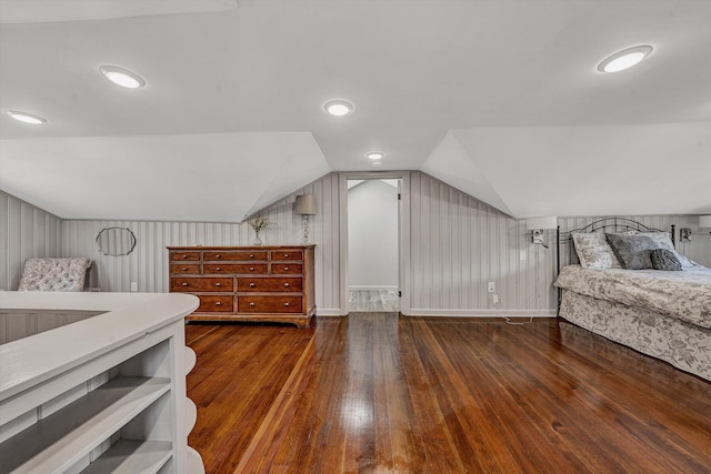 bedroom with hardwood / wood-style flooring, baseboards, and lofted ceiling