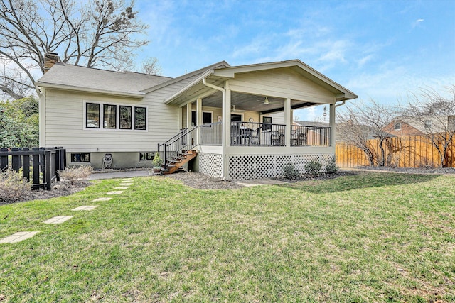 back of house with fence, a yard, roof with shingles, a wooden deck, and a chimney