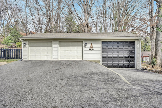 detached garage featuring fence