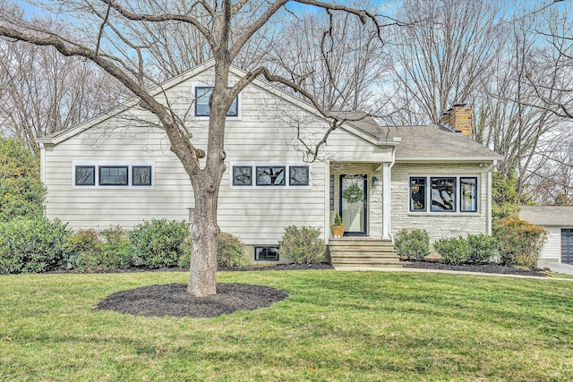 view of front of property featuring a shingled roof, a front lawn, and a chimney