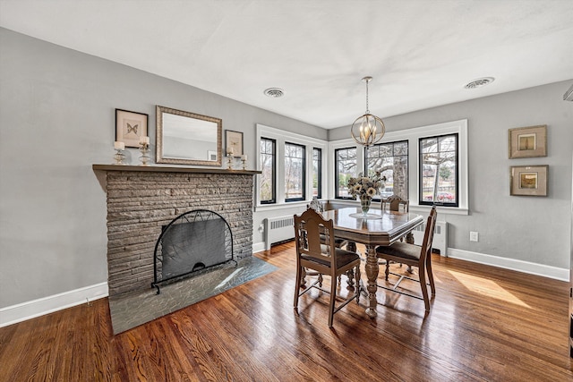 dining area with visible vents, baseboards, and wood finished floors