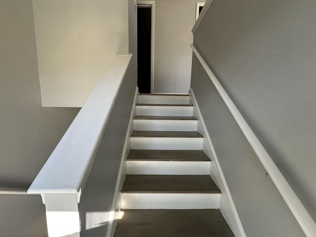 stairway with wood finished floors