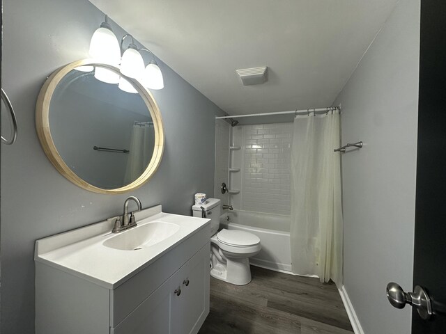 bathroom with toilet, shower / bathtub combination with curtain, wood finished floors, and vanity