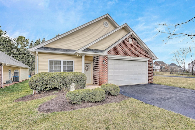 view of front facade with aphalt driveway, brick siding, central air condition unit, a front yard, and a garage