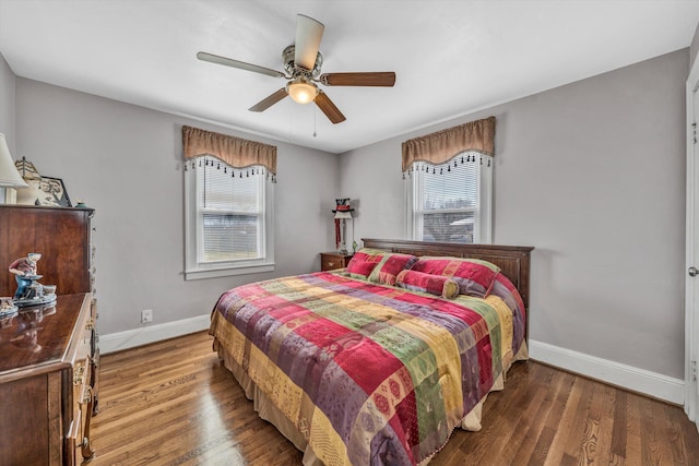 bedroom featuring wood finished floors, a ceiling fan, and baseboards