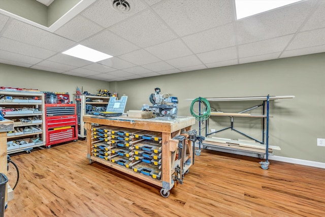 misc room with visible vents, a drop ceiling, and wood finished floors