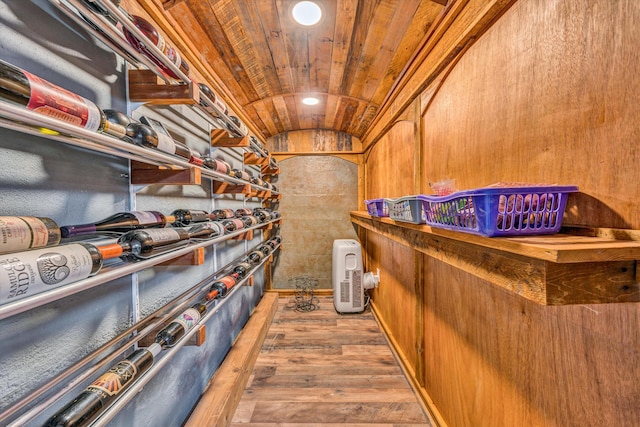 wine cellar featuring lofted ceiling, wood finished floors, and recessed lighting