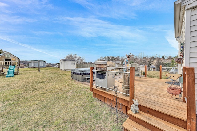 view of yard with a shed, a deck, and an outbuilding