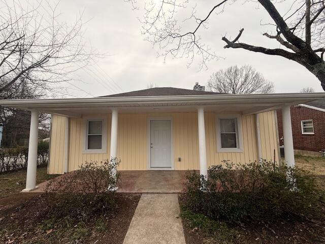 bungalow-style home featuring covered porch and board and batten siding