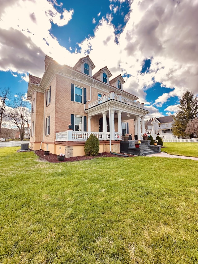 back of property with brick siding and a lawn