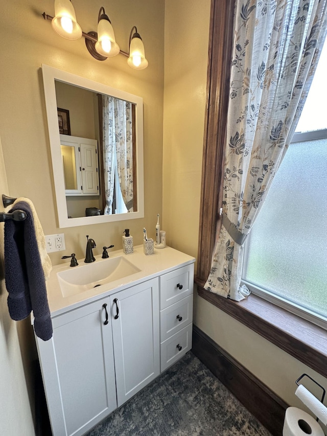 bathroom featuring vanity and baseboards