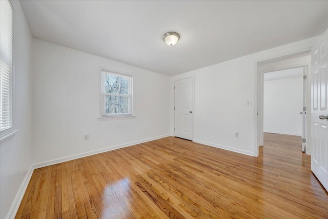 interior space with baseboards and light wood finished floors