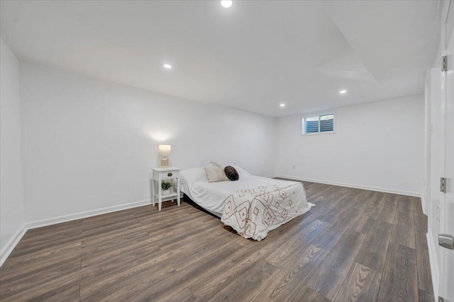 bedroom with recessed lighting, wood finished floors, and baseboards