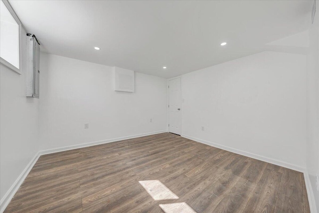 empty room featuring recessed lighting, baseboards, and wood finished floors