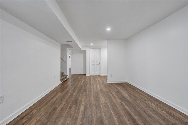 unfurnished living room with stairway, visible vents, baseboards, recessed lighting, and dark wood-style flooring