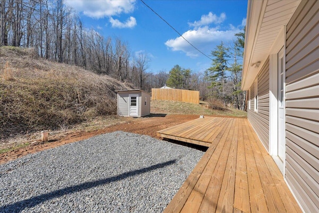 view of yard with an outbuilding, a storage shed, and a deck