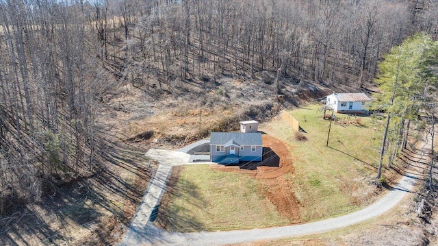 birds eye view of property featuring a view of trees