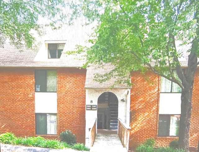 property entrance with brick siding