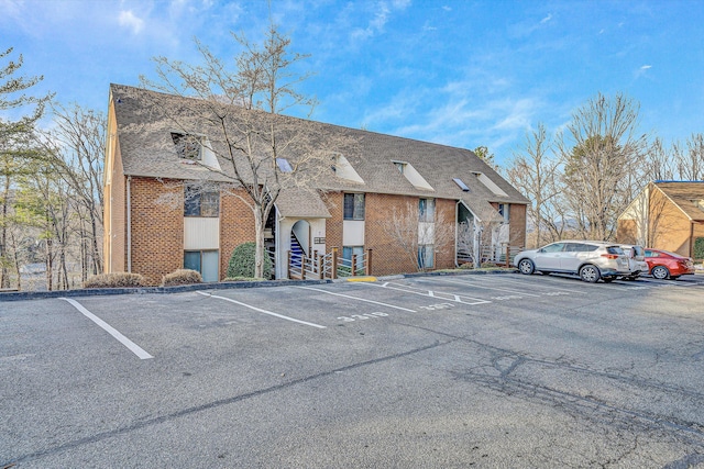 view of property featuring uncovered parking