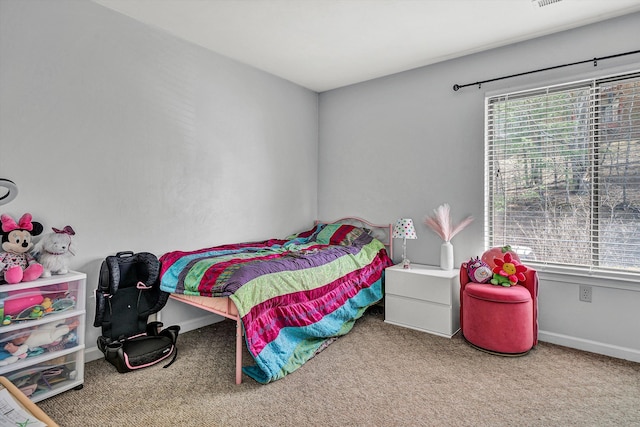 bedroom with baseboards and carpet