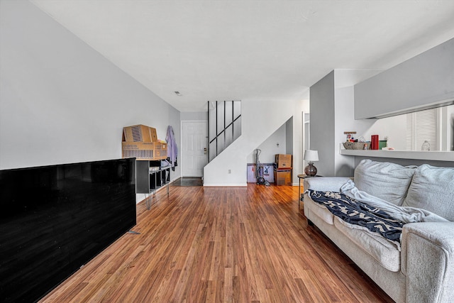 living room featuring stairs and wood finished floors