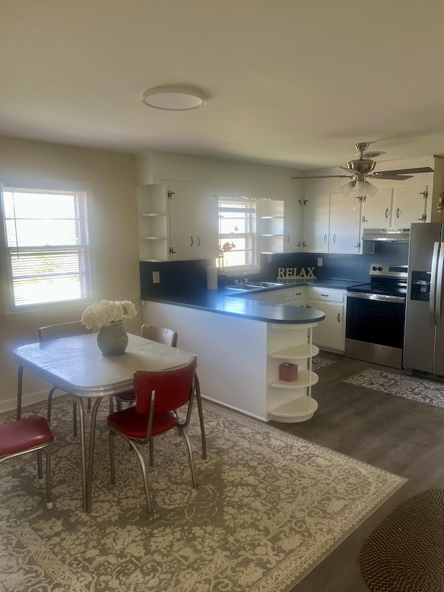 kitchen featuring appliances with stainless steel finishes, a wealth of natural light, white cabinetry, and open shelves