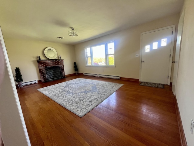 2811 Isle Of Pines Dr, Moneta, VA 24121 - living room featuring a baseboard heating unit, baseboard heating, wood finished floors, and a fireplace