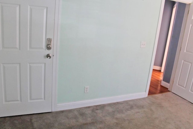 unfurnished room with carpet and baseboards