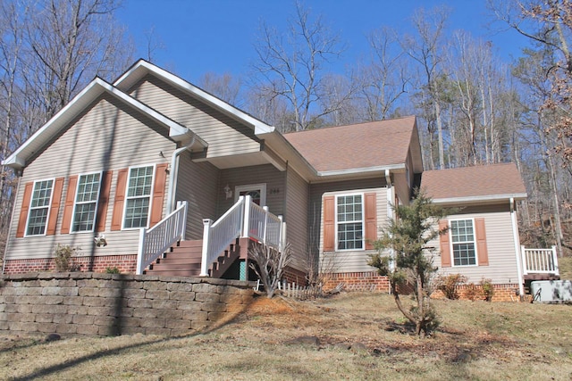 view of front of house with crawl space and roof with shingles