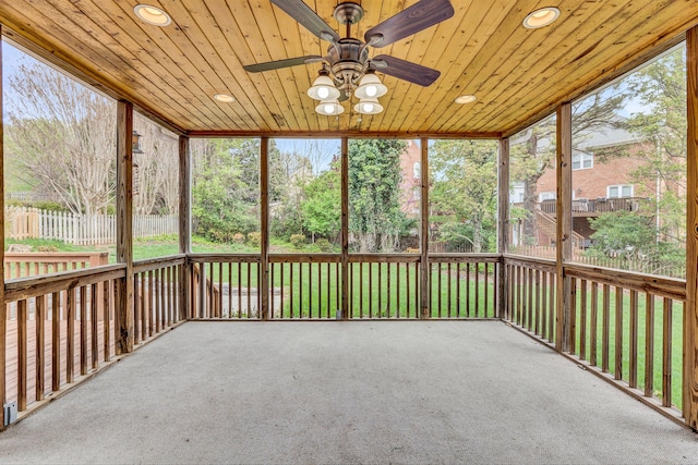 unfurnished sunroom featuring plenty of natural light, wood ceiling, and ceiling fan