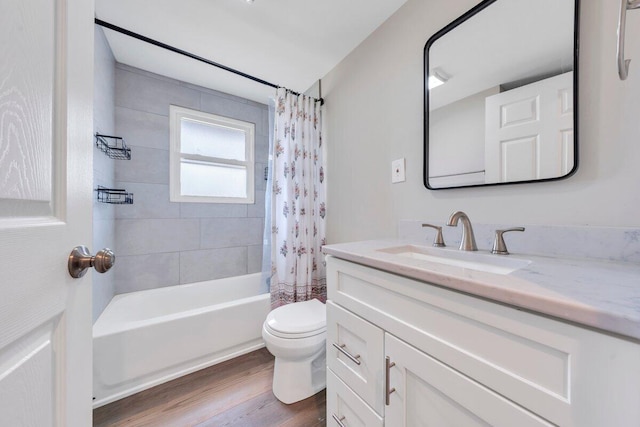 bathroom with vanity, wood finished floors, toilet, and shower / tub combo with curtain