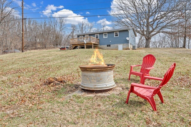 view of yard with a fire pit and a wooden deck