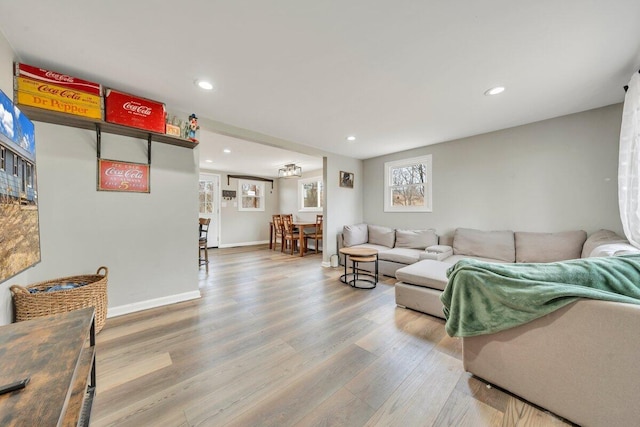 living area featuring recessed lighting, baseboards, and wood finished floors