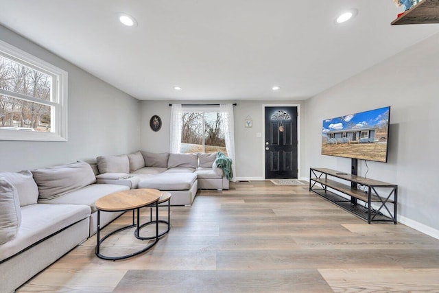 living area featuring recessed lighting, baseboards, and wood finished floors