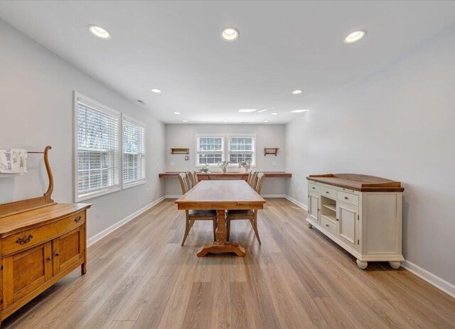 dining room with light wood-type flooring, baseboards, and recessed lighting