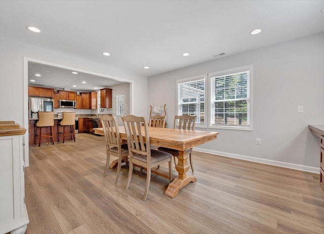 dining space with recessed lighting, baseboards, visible vents, and light wood finished floors