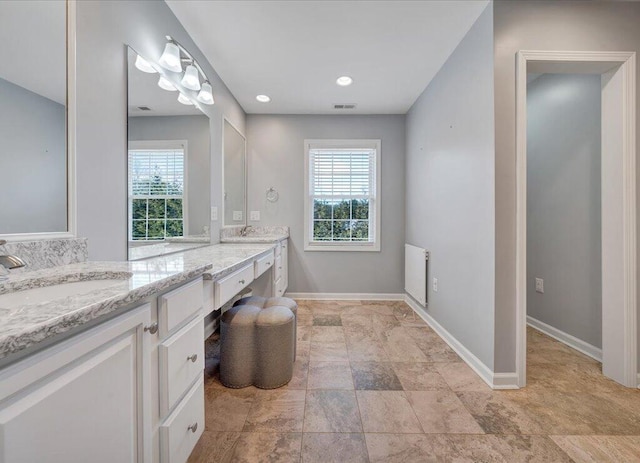 bathroom with a wealth of natural light, visible vents, and baseboards