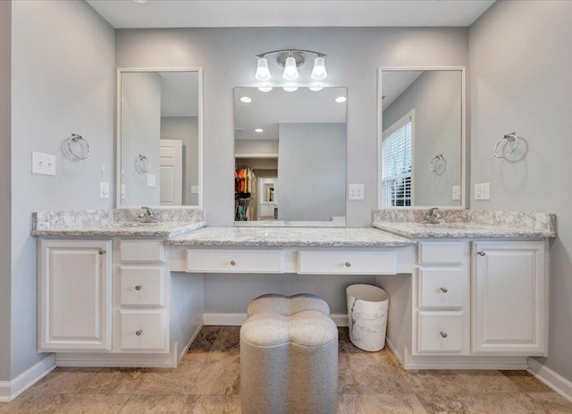 bathroom with vanity and baseboards