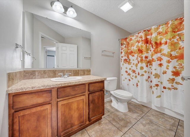 full bath with toilet, tile patterned flooring, a textured ceiling, and vanity