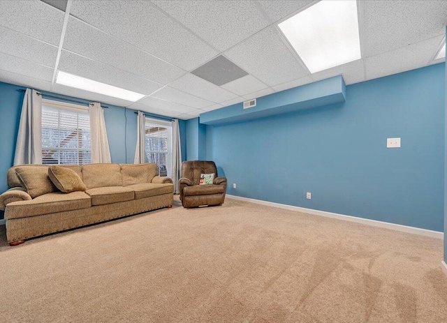 living area featuring a paneled ceiling, visible vents, baseboards, and carpet flooring