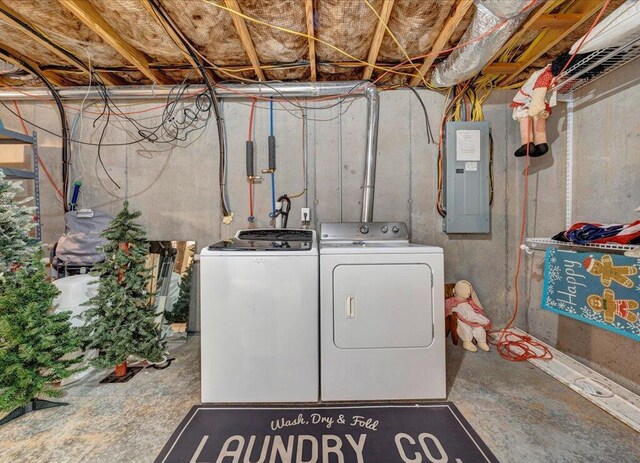 laundry room featuring laundry area, electric panel, and washer and clothes dryer