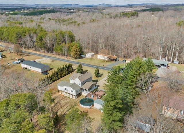 drone / aerial view featuring a wooded view