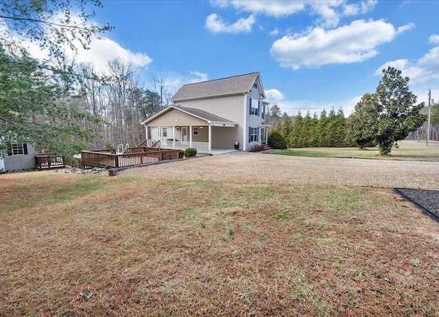 view of property exterior featuring a deck and a lawn