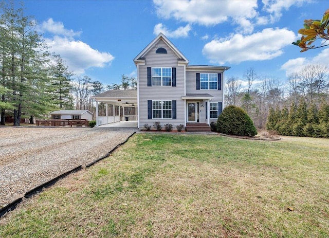 view of front of home with driveway, a front lawn, and a carport