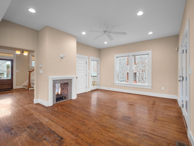 unfurnished living room with hardwood / wood-style flooring, recessed lighting, and a multi sided fireplace