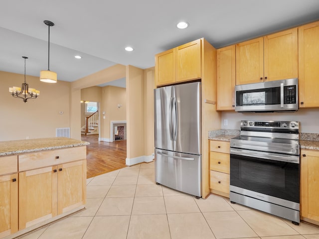 kitchen with recessed lighting, light brown cabinetry, and stainless steel appliances