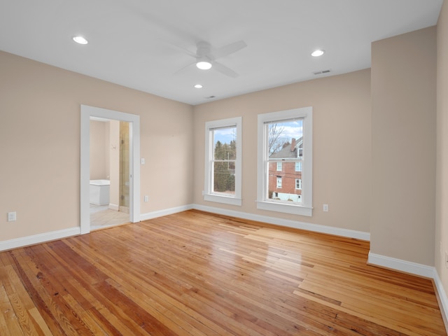 unfurnished room featuring visible vents, recessed lighting, light wood-type flooring, and baseboards